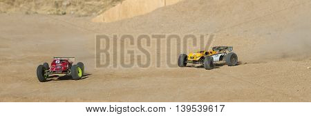 BOISE IDAHO-JULY 16 2016: Two RC cars lining up for the straight after a long sweeper during hte Boise Summer Blase Rc race