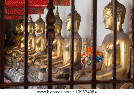 Gold Buddha Statue In Public Temple In Thailand. Row Of Buddha Imanges In Different Posture.