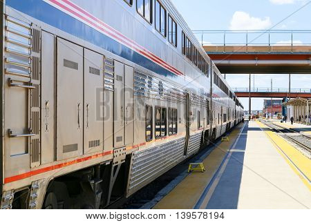 ALBUQUERQUE, USA - MAY 24, 2015: The Amtrak passenger train Southwest Chief stopping with steps placed on the platform in front of the doors to get on the train easier.