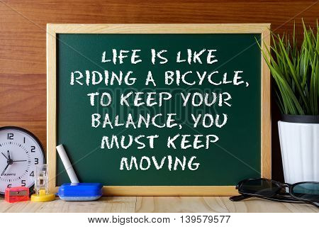 Word Quote Life Is Like Riding A Bicycle,to Keep Your Balance,you Must Keep Moving Written On Green