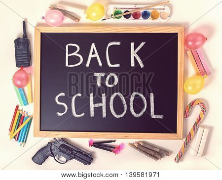 Top Down Concept Of Education With Text Back To School Is Written In Chalkboard, Chalks, Toys And Co