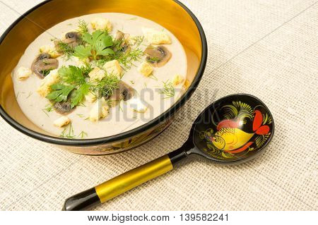 Cream soup with mushrooms herbs and croutons