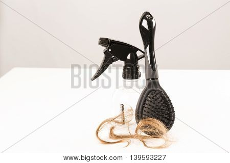 Close-up of hair loss, long hair, alopecia on white background with brush, comb nobody