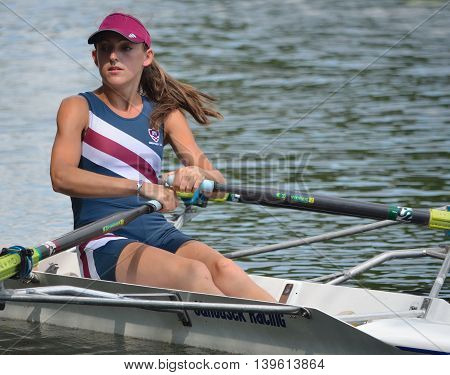 St Neots, Cambridgeshire, England - July 23, 2016: Close up of Female Sculler in blue on the River Ouse.