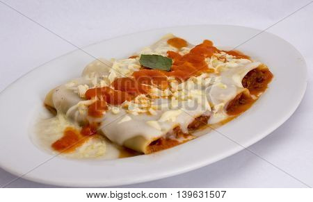 Canelones Italian Dish Bolognese style (caneloni). tomatoes sauce, bechamel, grounded beef meat, basil.