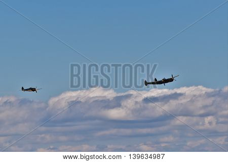 DELTA, BC, CANADA.  JULY 23, 2016. American P-38L Lightning  and a Japanese Nakajima KI-43 Oscar perform at the Boundary Bay Airshow.