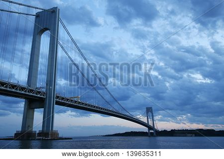 NEW YORK - JULY 23, 2016: Verrazano Bridge at dusk in New York.The Verrazano Bridge is a double-decked suspension bridge that connects the boroughs of Staten Island and Brooklyn