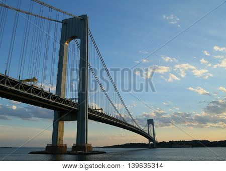 NEW YORK - JULY 23, 2016: Verrazano Bridge at dusk in New York.The Verrazano Bridge is a double-decked suspension bridge that connects the boroughs of Staten Island and Brooklyn