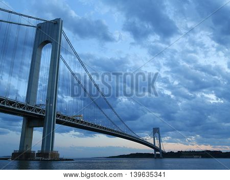 NEW YORK - JULY 23, 2016: Verrazano Bridge at dusk in New York.The Verrazano Bridge is a double-decked suspension bridge that connects the boroughs of Staten Island and Brooklyn