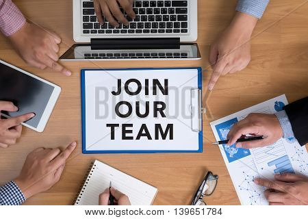 Business Team Hands At Work With Financial Reports And A Laptop, Join Our Team Concept