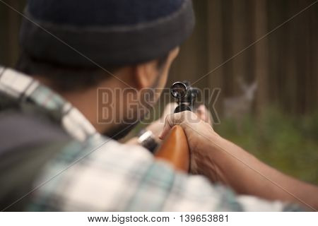 Interracial hunter man in the forest. Sport hunting