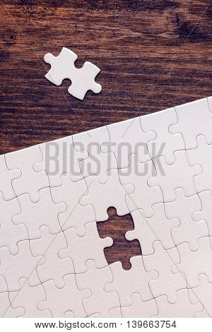 Jigsaw puzzle with one missing piece left to complete copy space top view