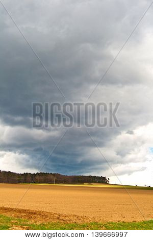 Dark Clouds And Blue Sky Over Fields