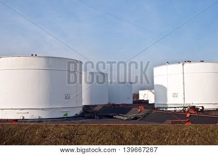 White Tanks In Tank Farm With Blue Sky