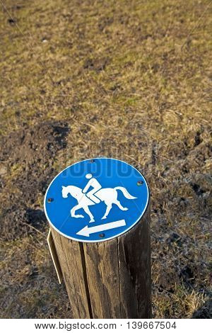 sign riding allowed nailed on a stem in the forest