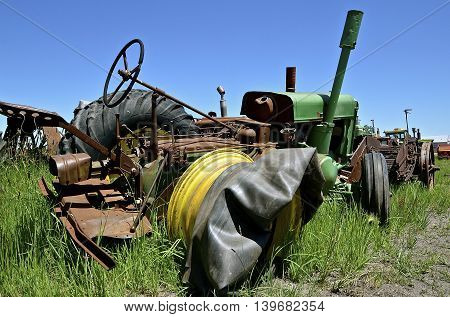 An old tractor without a tire and inner tube laying on the rim.