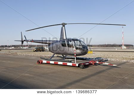 Helicopter at the airport, in front of blue sky.