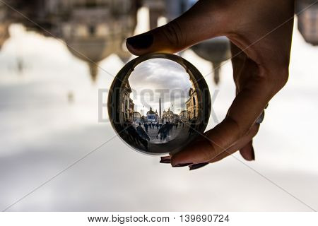 Piazza del Popolo in Rome Italy with Dramatic Clouds through Glass Sphere Perspective