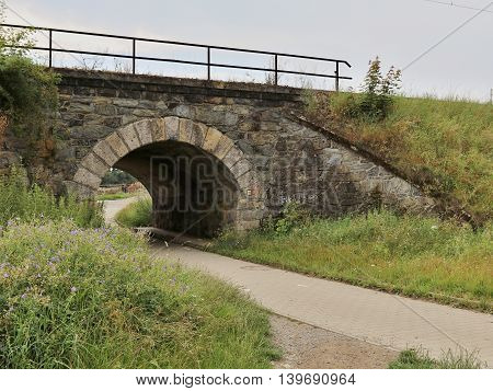 Old small stone railroad bridge in nature