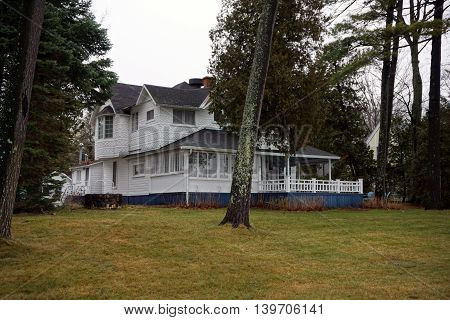 WEQUENTONSING, MICHIGAN / UNITED STATES - DECEMBER 23, 2015: A white mansion on Beach Drive in Wequetonsing.
