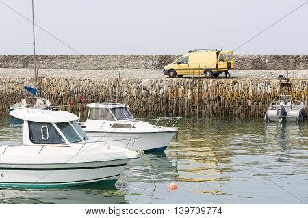 Small fishing boats waiting in port France water reflection