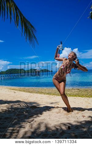 Photo young girl playing on beach snorkeling equipment. Smiling woman spending chill time outdoor summer Bali island. Horizontal picture