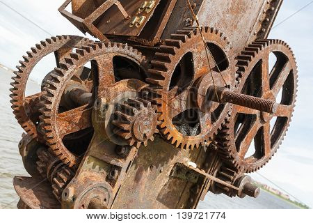 rusty gears and winch mechanism in Fort Alexander Chumnoy in the Gulf of Finland