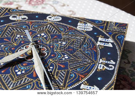 blue square hand-painted watch with contour acrylic paints in the technique point to point, with a geometric pattern in the form of a mandala, white numerals and silver arrows