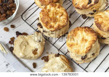 Fruit scones on rack.  Top view.  With sultanas and butter.