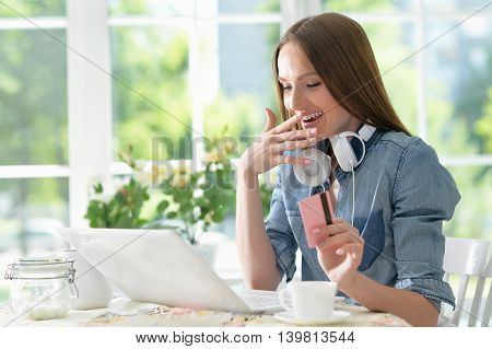 Portrait of attractive young woman using laptop