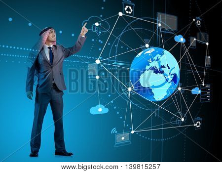 Arab man pressing dots on world map in global communication conc