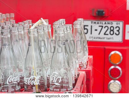 BANGKOK, THAILAND - JUNE 25: Empty recycle bottles of Coca Cola in red plastic box on June 25, 2016 in Bangkok, Thailand. Coca Cola drinks are produced and manufactured by The Coca-Cola Company