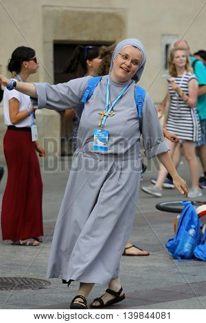 CRACOW POLAND - JULY 24 2016: Pilgrims of World Youth Day sing and dance on the Main Square in Cracow. Poland