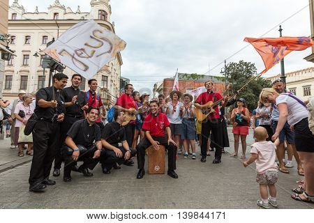 CRACOW POLAND - JULY 24 2016: Pilgrims of World Youth Day sing and dance on the Main Square in Cracow. Poland