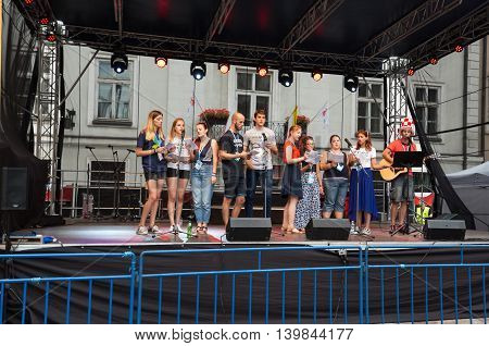CRACOW POLAND - JULY 24 2016: Pilgrims of World Youth Day sing and dance on the St. Maria Magdalena Square in Cracow. Poland