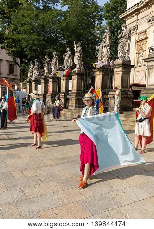 CRACOW POLAND - JULY 24 2016: Pilgrims of World Youth Day sing and dance on the St. Maria Magdalena Square in Cracow. Poland