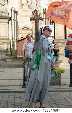 CRACOW POLAND - JULY 24 2016: Pilgrims of World Youth Day sing and dance on the St. Maria Magdalena Square in Cracow. Poland