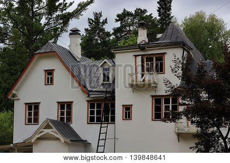 White vintage mansion in the trees photo