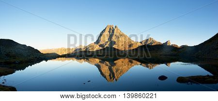Midi Dossau Peak reflected in Miey lake. Ossau Valley, Pyrenees National Park, Pyrenees, France.