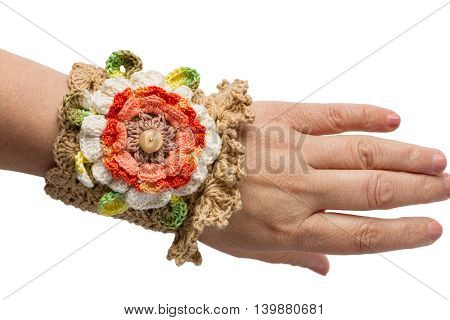 Brown hand- Knitted bracelet isolated on womans hand
