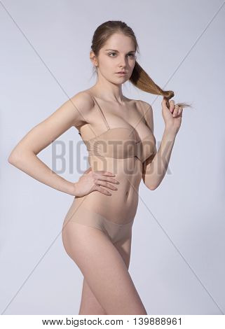 portrait of attractive caucasian slim woman isolated on white studio shot looking at camera