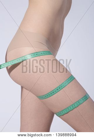 Body of woman with a measuring tape
