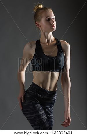 Beautiful sexy blonde woman perfect athletic slim figure engaged in yoga exercise or fitness lead healthy lifestyle eats right dressed in comfortable casual clothes sport pilates diet