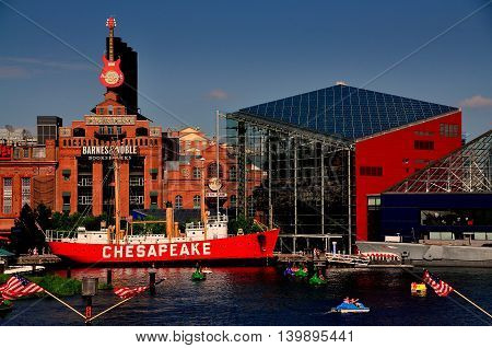 Baltimore Maryland - July 22 2013: Lightship Chesapeake moored in front of the Power Plant commercial complex next to the ultra-modern National Aquarium