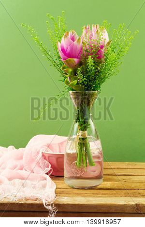 Beautiful pink flower bouquet over green background