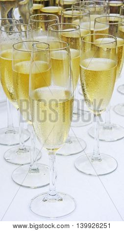 Several white champagne vine glasses. Wedding abstraction.