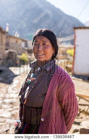 Jhong, Nepal - May 13, 2016: Portrait of an unidentified tibetan woman in the Himalayas mountains in Jhong village, Nepal.