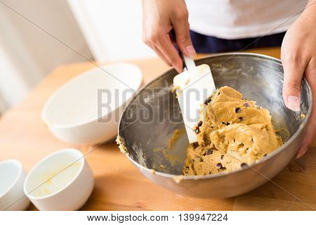 Woman mixing the drough to make chocolate cookies