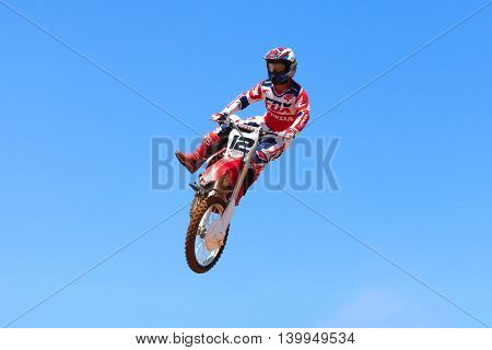 Wingate, Israel - July 23, 2016: Motocross rider and bike clearing a tabletop jump during the final heat of the race.