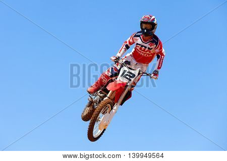 Wingate, Israel - July 23, 2016: Motocross rider and bike clearing a tabletop jump during the final heat of the race.